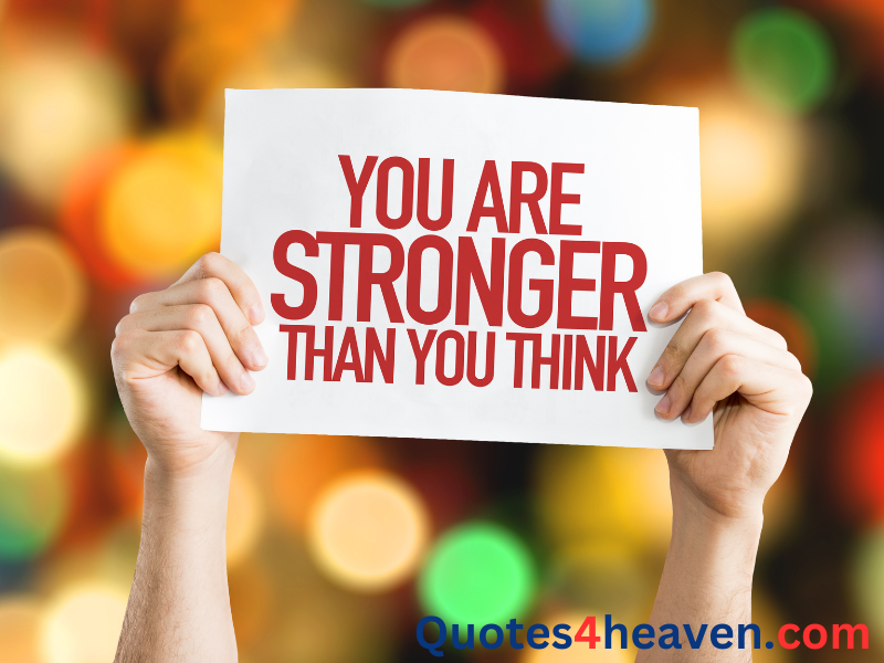 The image shows two hands holding up a white sign with the quote "YOU ARE STRONGER THAN YOU THINK" written in bold, red text. In the bottom right corner, there is a web address displayed as Quotes4heaven.com in blue and red text. The background is a blurred array of colorful lights, creating a warm, motivational atmosphere.