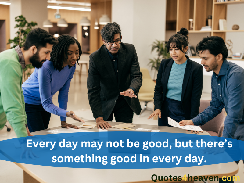 The image shows a group of professionals gathered around a table, engaging in a discussion or planning session in a modern office setting. Overlaid text in white on a blue banner reads, "Every day may not be good, but there’s something good in every day." The watermark "Quotes4heaven.com" appears at the bottom right in green.